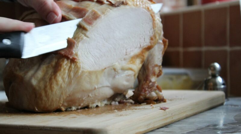 Carving a roast turkey on a wooden board